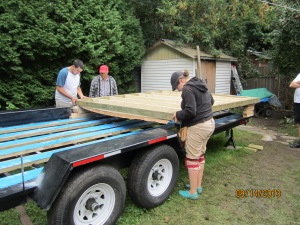 My cousin Alex and raising the subfloor up over the rods so that the holes could be drilled for the rods to fit through.