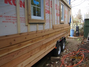 The far wall with half of the siding up.