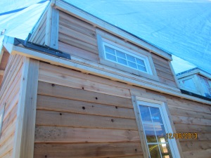 A dormer with all of the siding up.